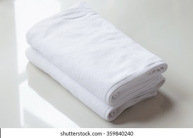 Stacked White Spa Cloth Beach Towels On Marble  Background. 