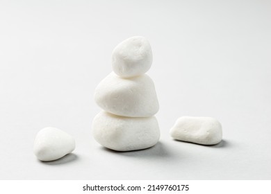 Stacked White Zen Rocks Balance On The Grey Background. Balancing Pebble Stones 