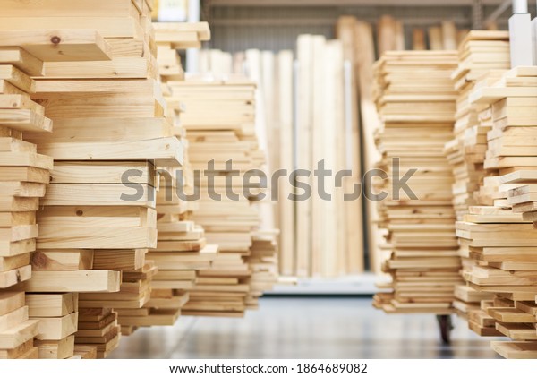 stacked wooden boards in a woodworking\
industry. stacks with pine lumber. folded edged board. wood\
harvesting shop. timber for\
construction