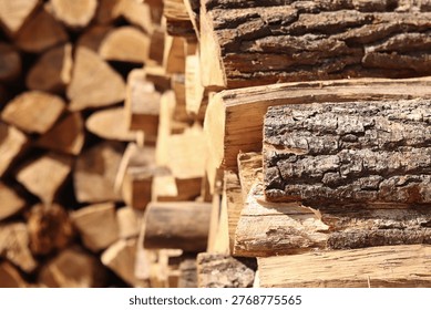 Stacked wooden logs. Close-up of stacked firewood. Natural wooden background. Background of chopped firewood ready to use. Suitable for themes related to heating, nature or rural life