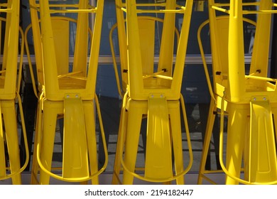 Stacked Yellow Metal Bar Stool Chairs