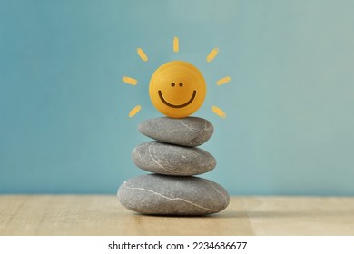 Stacked Zen stones with Happy round face - Concept of mental balance and positivity