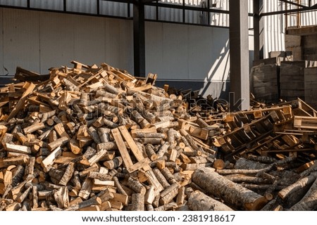 Stacking Firewood. Pile of firewood loggs. Preparation for winter heating season. Firewood background