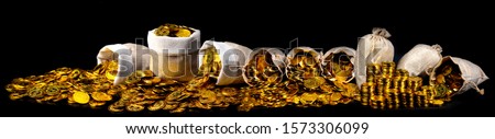 Stacking gold coin in treasure sack lot of at black background, Money stack for business planning investment and saving the future concept