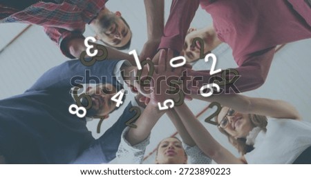 Stacking hands, five in shirts huddling in meeting under panel ceiling showing digits, glasses. Teamwork, collaboration, colleagues, office, conference, unity, lowangle