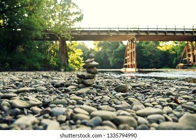stacking rocks by a river