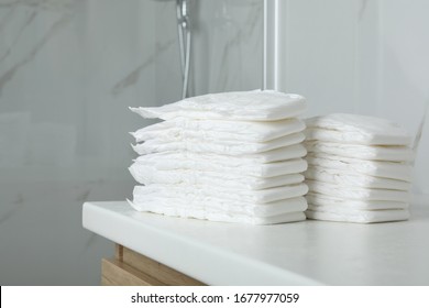 Stacks Of Baby Diapers On Counter In Bathroom