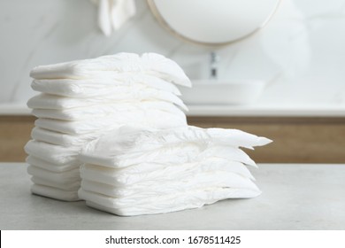 Stacks Of Baby Diapers On Counter In Bathroom