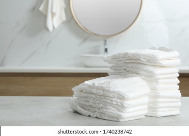 Stacks Of Baby Diapers On Counter In Bathroom