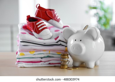 Stacks Of Baby Linen And Money Box On The Table