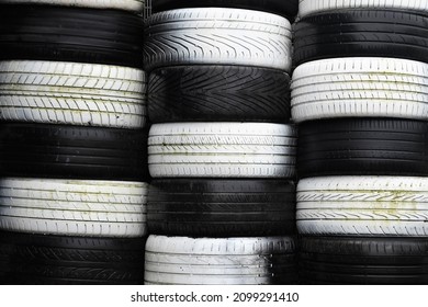 Stacks of black and white old tyres tires, forming a chequed checkered pattern. - Powered by Shutterstock