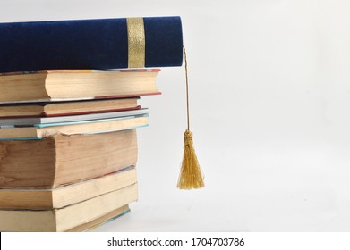 stacks of books and diploma on white background