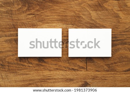 Stacks of businesscards with copy space on wooden background