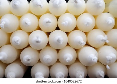 Stacks of candles with selective focus in a shelf shown in a small store