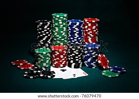 stacks of chips for poker with pair of aces