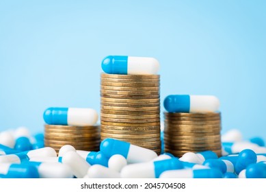 Stacks of coins between medical pills capsules. Concept of expensive medicine - Shutterstock ID 2045704508