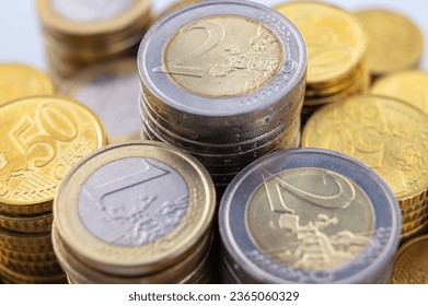 Stacks of coins next to each other, on white surface. Quantity of money, currency and wealth. - Shutterstock ID 2365060329