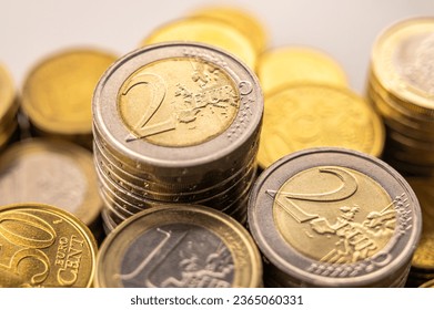 Stacks of coins next to each other, on white surface. Quantity of money, currency and wealth. - Shutterstock ID 2365060331