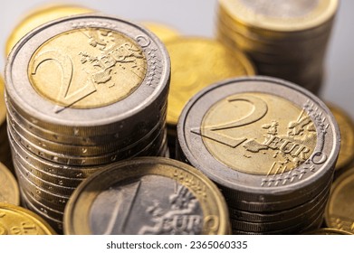 Stacks of coins next to each other, on white surface. Quantity of money, currency and wealth. - Shutterstock ID 2365060335