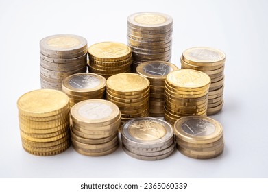 Stacks of coins next to each other, on white surface. Quantity of money, currency and wealth. - Shutterstock ID 2365060339