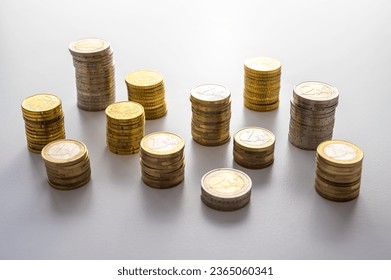 Stacks of coins next to each other, on white surface. Quantity of money, currency and wealth. - Shutterstock ID 2365060341
