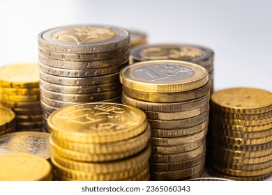 Stacks of coins next to each other, on white surface. Quantity of money, currency and wealth. - Shutterstock ID 2365060343