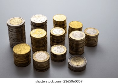 Stacks of coins next to each other, on white surface. Quantity of money, currency and wealth. - Shutterstock ID 2365060359