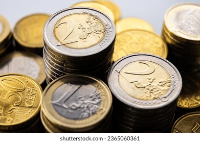 Stacks of coins next to each other, on white surface. Quantity of money, currency and wealth. - Shutterstock ID 2365060361