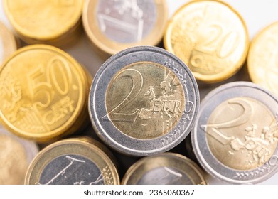 Stacks of coins next to each other, on white surface. Quantity of money, currency and wealth. - Shutterstock ID 2365060367