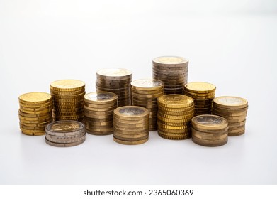 Stacks of coins next to each other, on white surface. Quantity of money, currency and wealth. - Shutterstock ID 2365060369