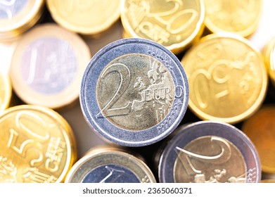 Stacks of coins next to each other, on white surface. Quantity of money, currency and wealth. - Shutterstock ID 2365060371