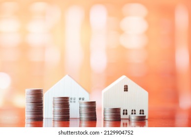 Stacks Of Coins On Desk With Mockup Wooden Houses; Investments; Business Growth; Saving Money; Transactions; Taxes; Building A House; Borrowing Money; Bank Deposits; Financial Management; Target.
