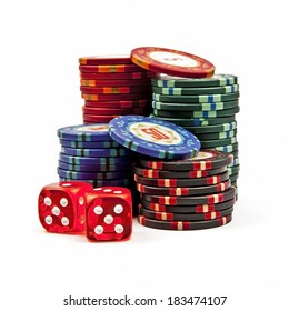 Stacks colored poker chips with dices isolated over white background