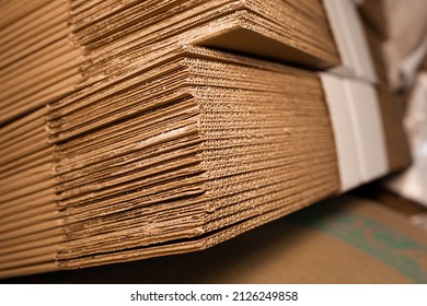 stacks of containerboard sheets in warehouse facility