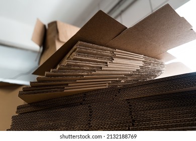 stacks of containerboard sheets in warehouse facility