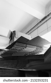 stacks of containerboard sheets in warehouse facility, monochrome