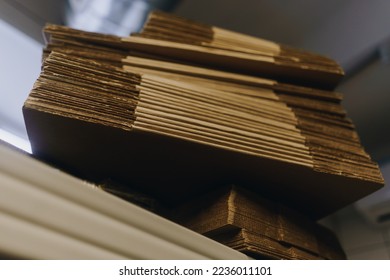stacks of containerboard sheets in warehouse facility