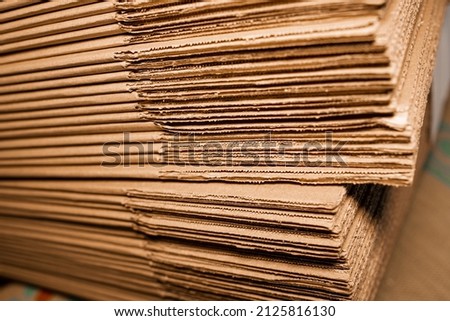 stacks of containerboard sheets in warehouse facility