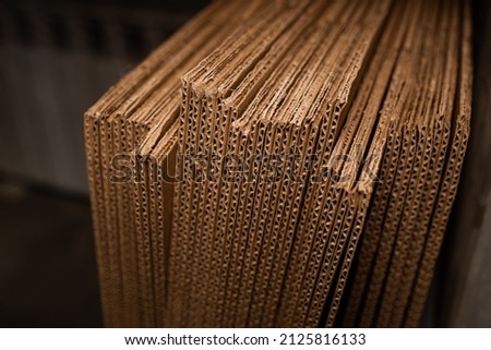 stacks of containerboard sheets in warehouse facility