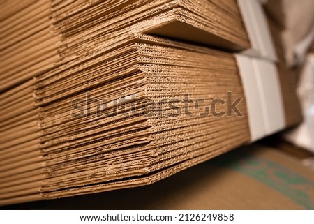 stacks of containerboard sheets in warehouse facility