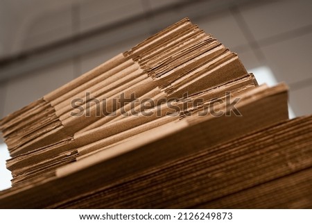 stacks of containerboard sheets in warehouse facility