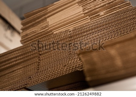 stacks of containerboard sheets in warehouse facility