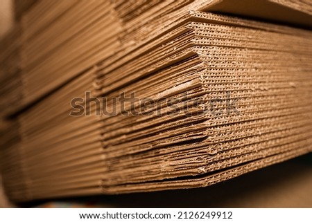 stacks of containerboard sheets in warehouse facility