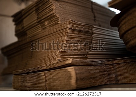 stacks of containerboard sheets in warehouse facility