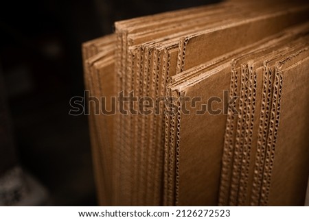 stacks of containerboard sheets in warehouse facility