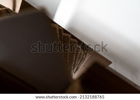 stacks of containerboard sheets in warehouse facility