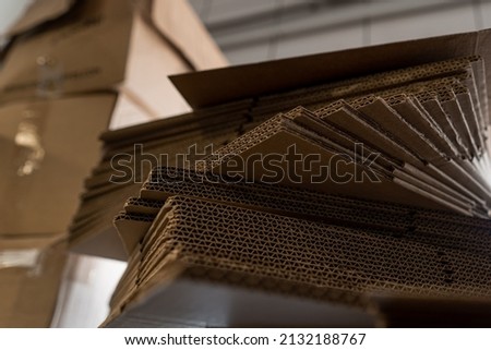 stacks of containerboard sheets in warehouse facility