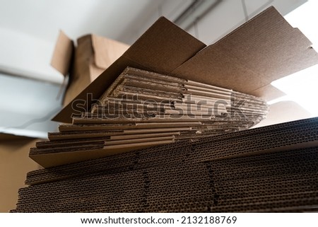 stacks of containerboard sheets in warehouse facility