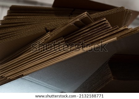 stacks of containerboard sheets in warehouse facility