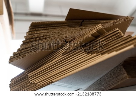 stacks of containerboard sheets in warehouse facility